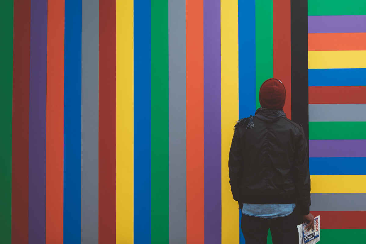 A person examining a collage of colors